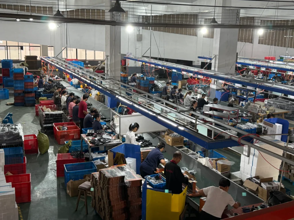 An elevated view of workers assembling electric hot plates on parallel AOFENG production lines